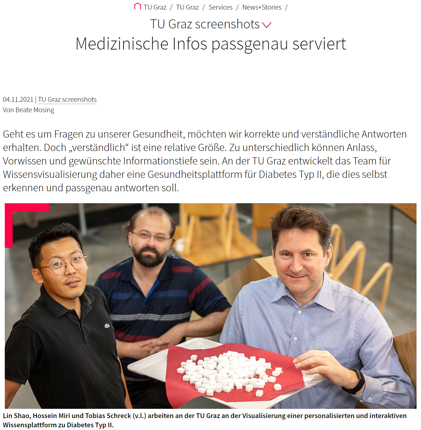 Three men look at the camera. One of them is holding a tray with lots of sugar cubes.